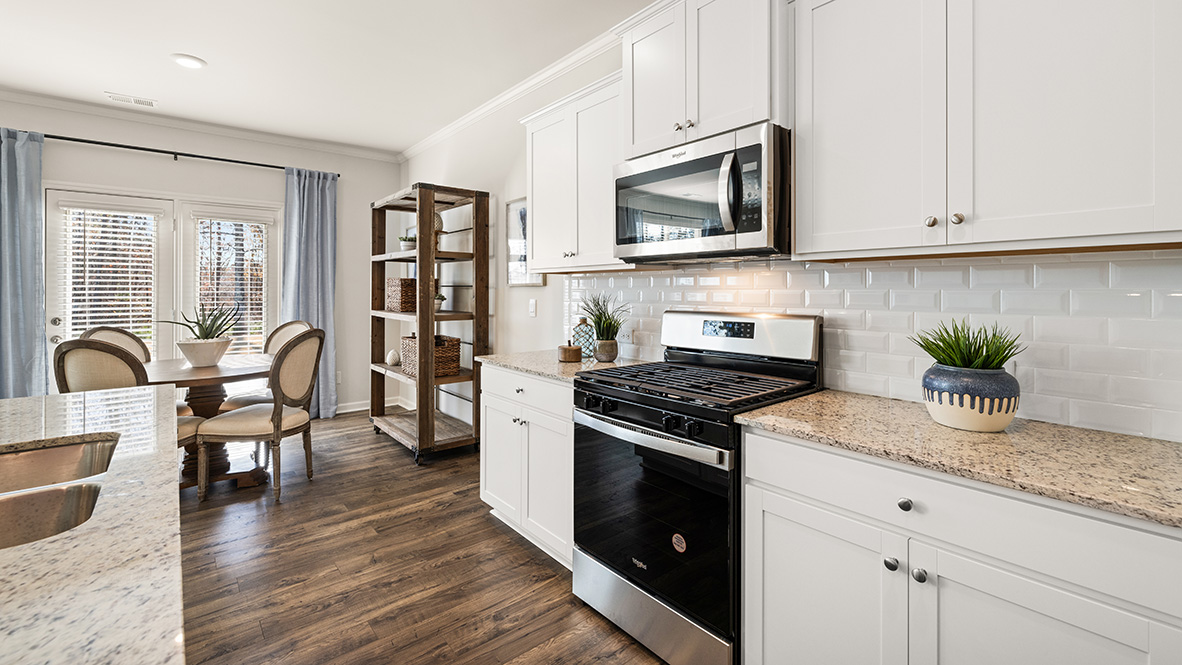 Interior kitchen with center island and white cabinets