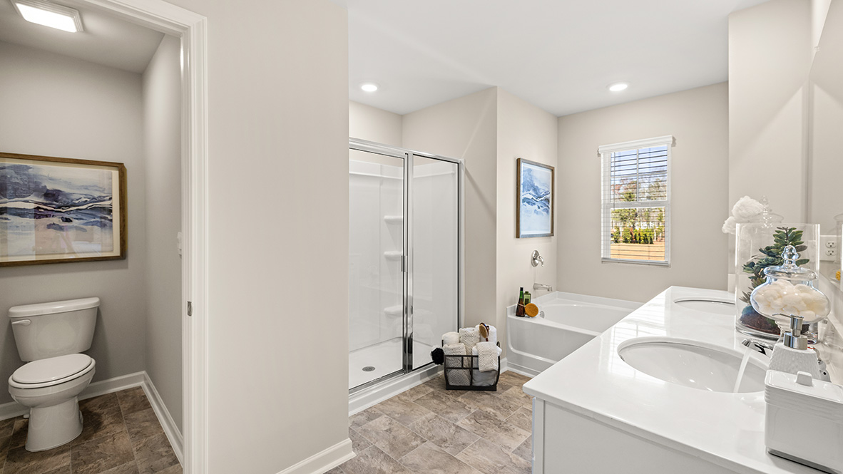 Interior primary bathroom with double sink and shower