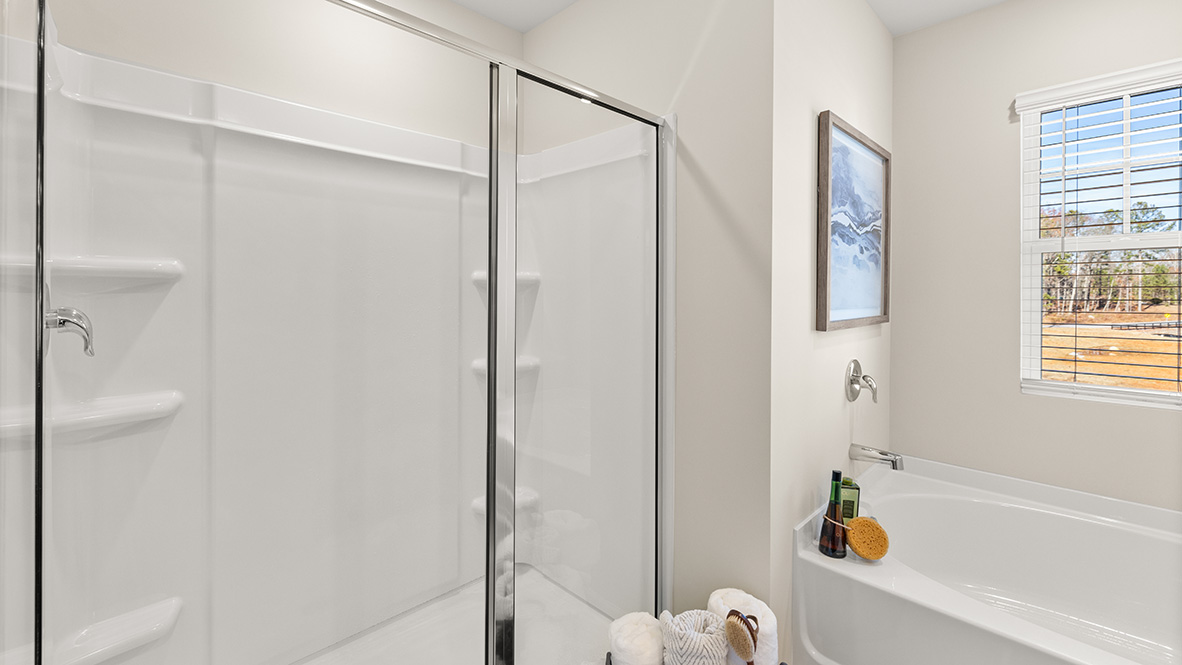 Interior primary bathroom with shower and bath tub