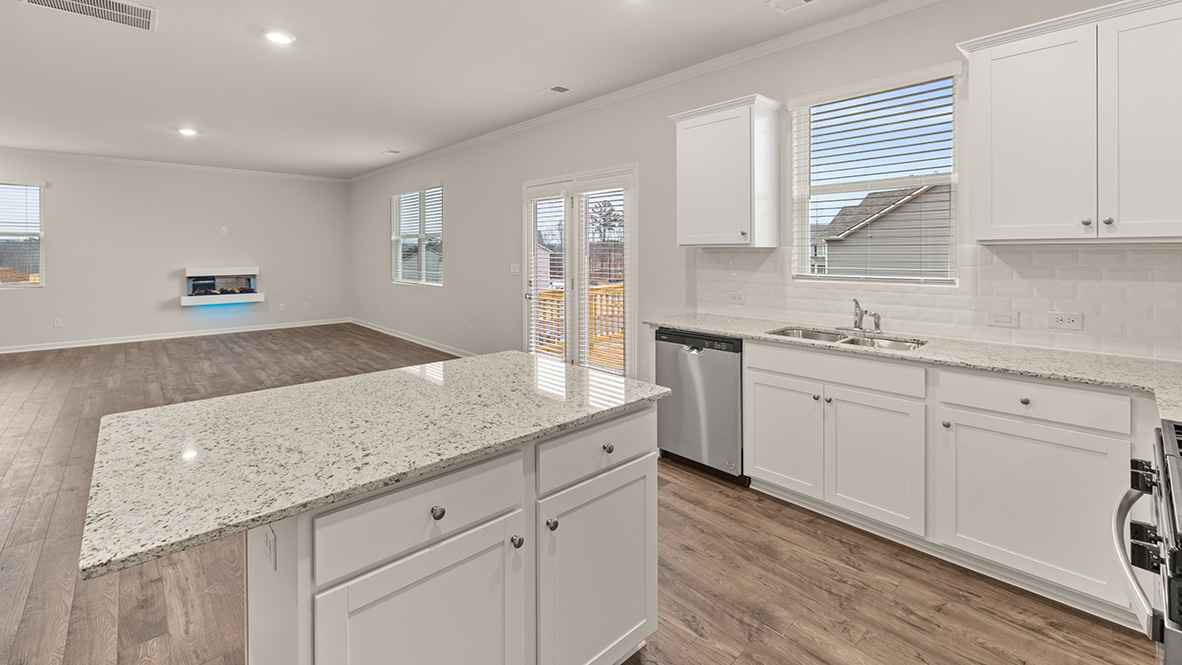 mansfield kitchen with white cabinets that opens to living room at thompson ridge in dallas georgia