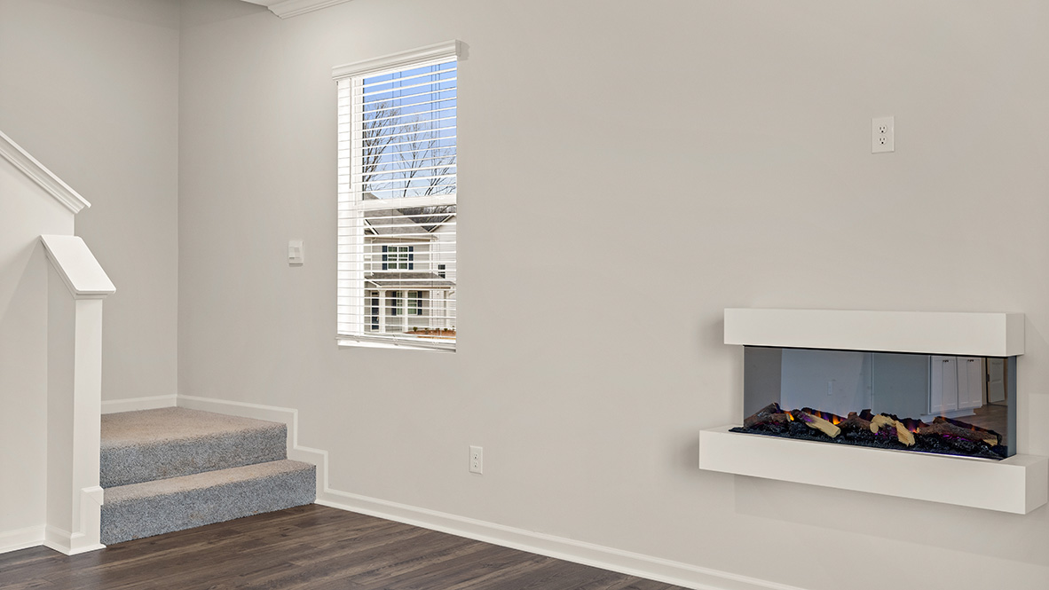 living room with a floating electric fireplace