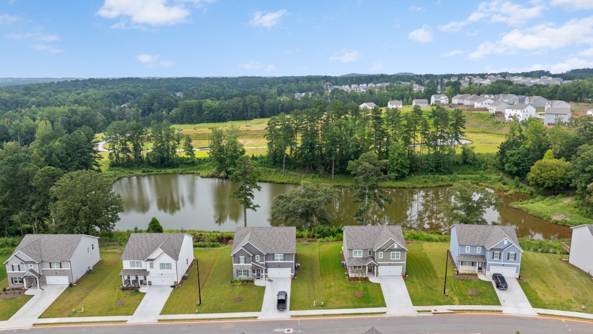 thompson ridge streetscape with large pond behind homes