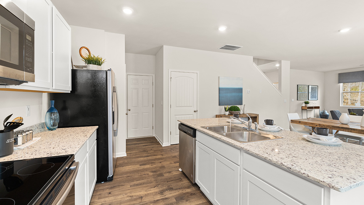 Interior kitchen with center island and white cabinets