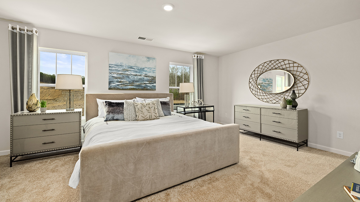 Interior primary bedroom with large windows