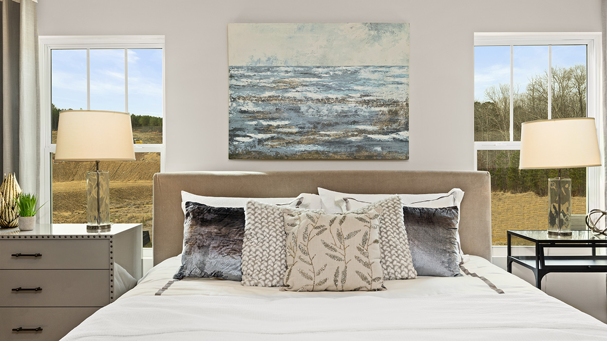 Interior primary bedroom with large windows