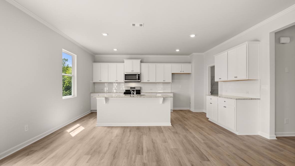 Interior kitchen with center island and white cabinets