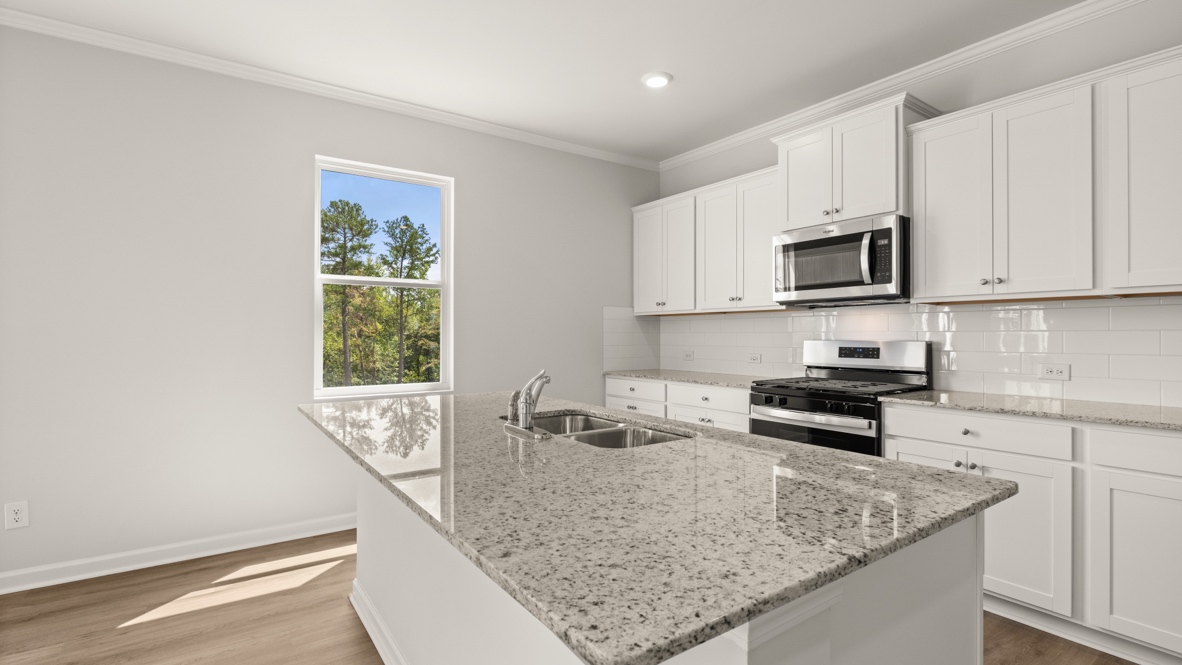Interior kitchen with center island and white cabinets