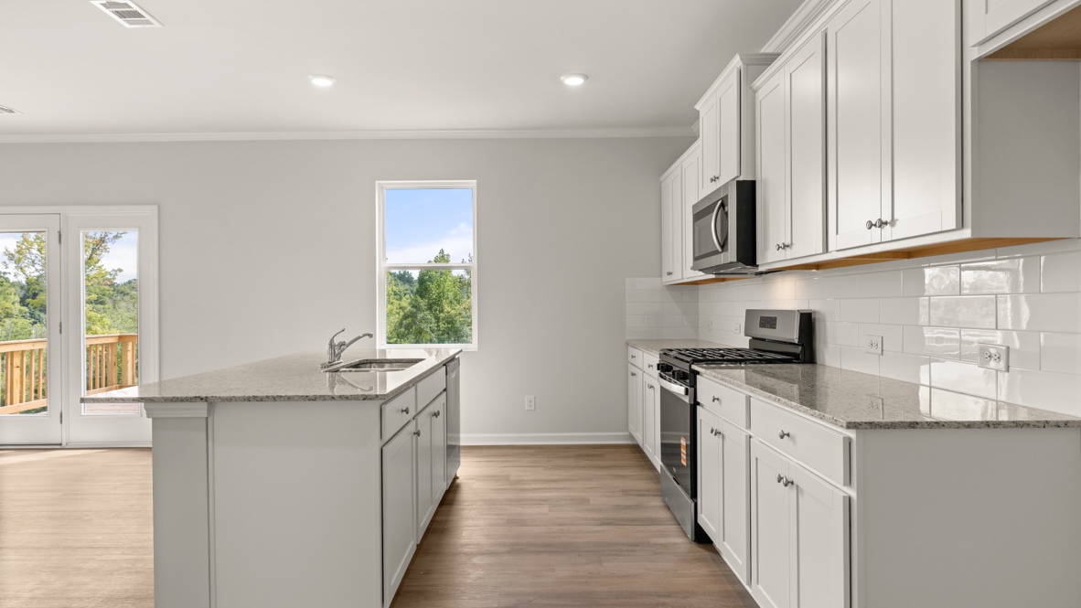 Interior kitchen with center island and white cabinets