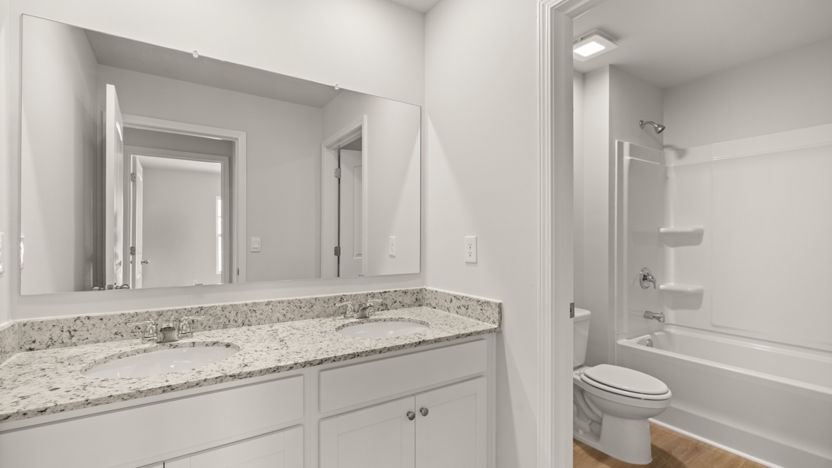 Interior bathroom with double sink and full-sized shower