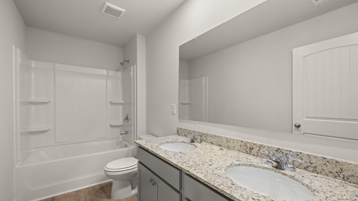 Interior bathroom with double sink and full-sized shower