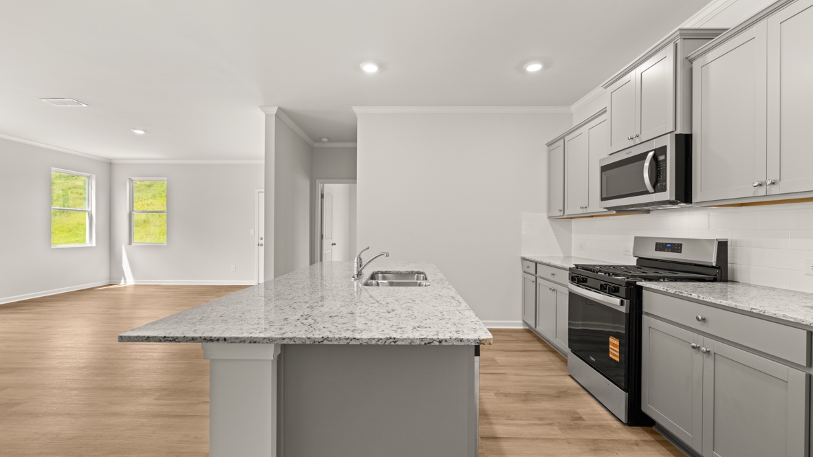 Interior kitchen with center island and light grey cabinets