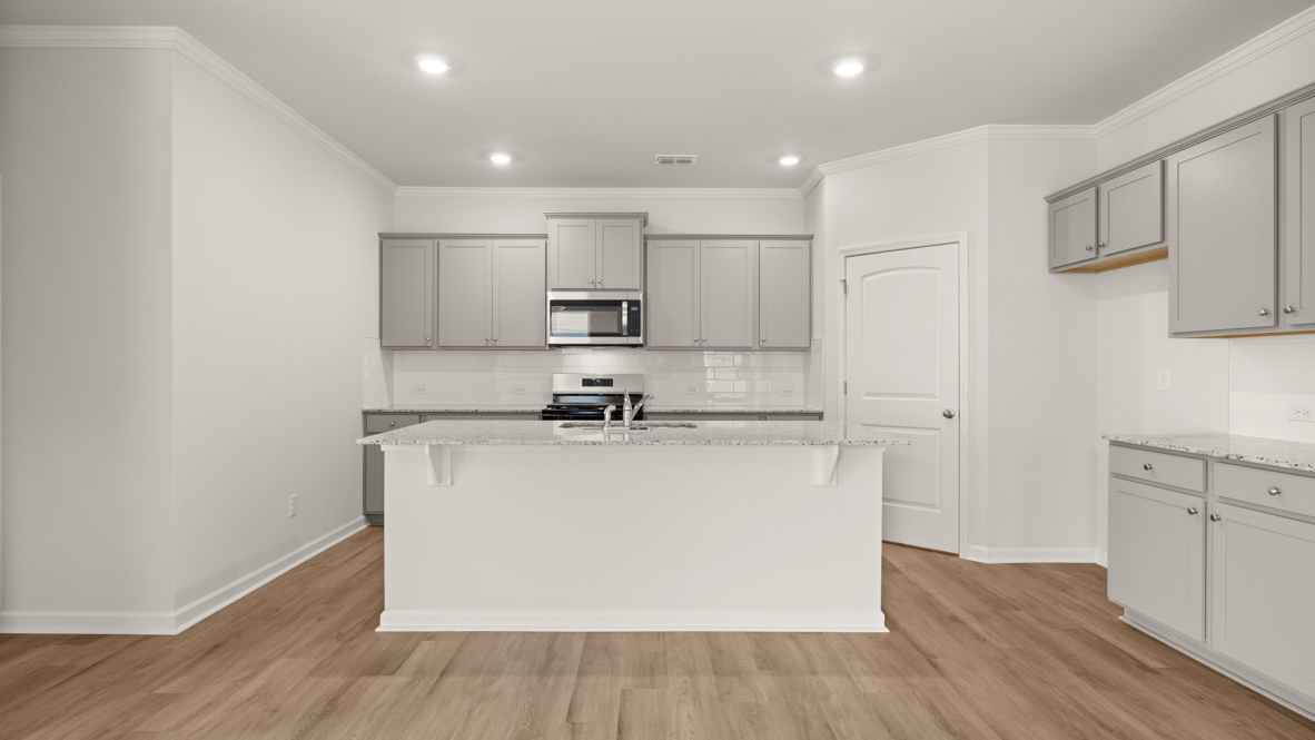 Interior kitchen with center island and light grey cabinets