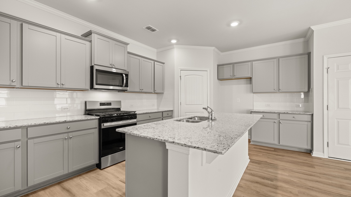 Interior kitchen with center island and light grey cabinets