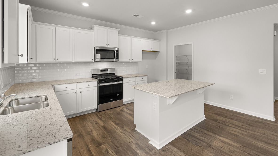 Interior kitchen with center island and white cabinets