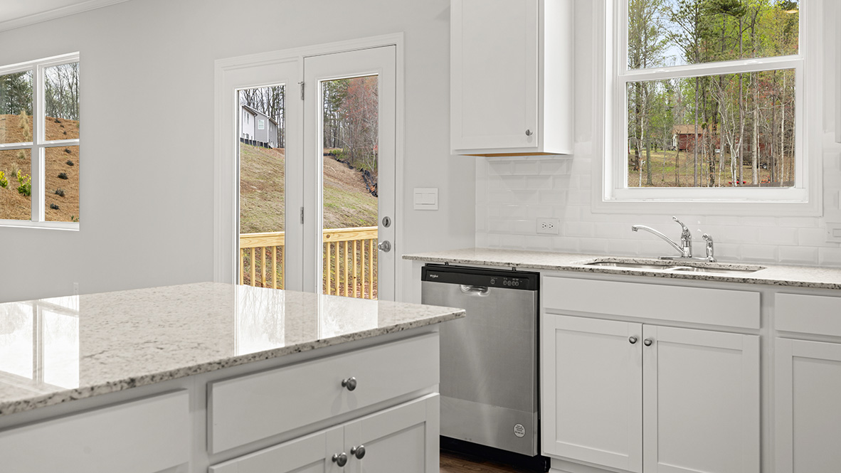 Interior kitchen with center island and white cabinets