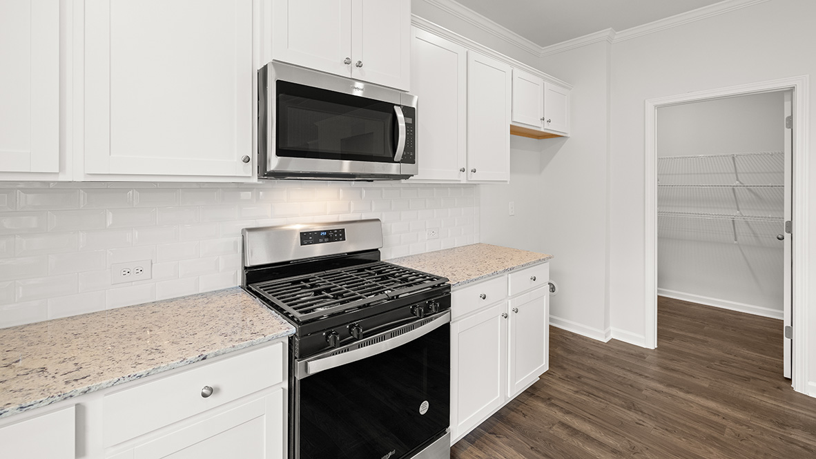 Interior kitchen with center island and white cabinets