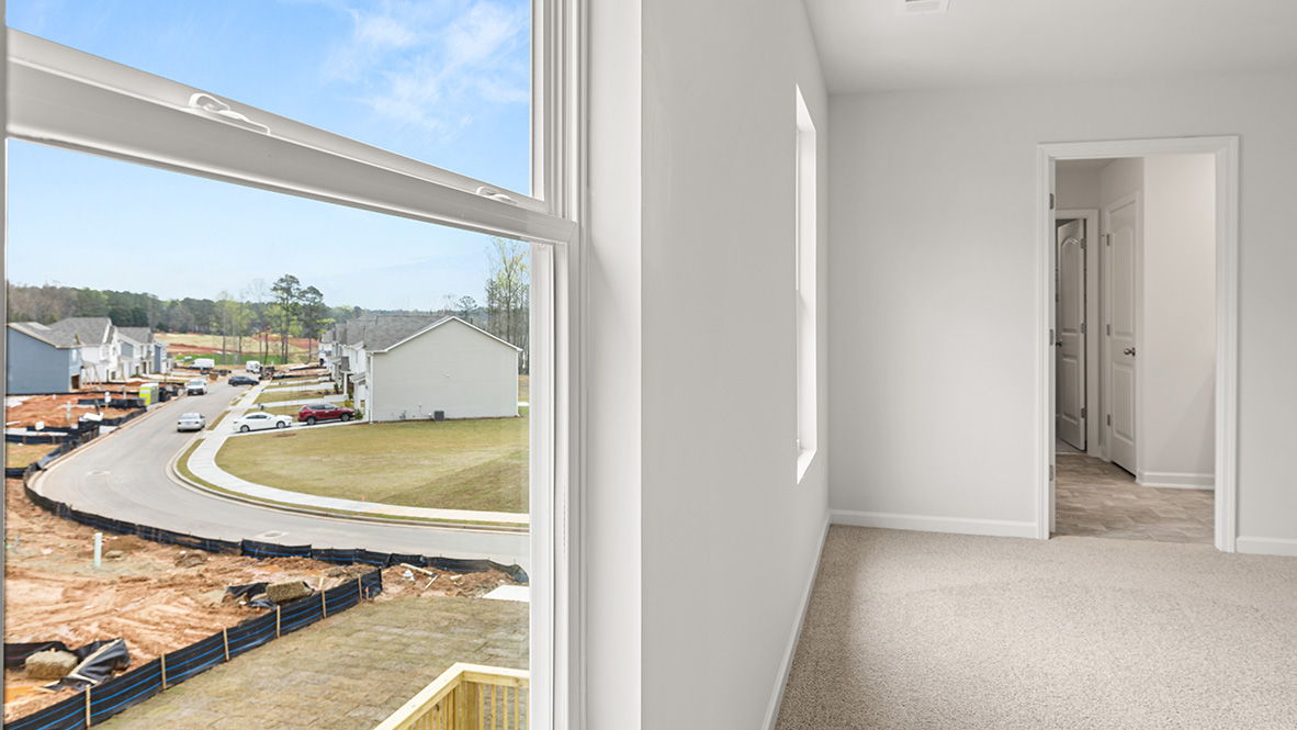 Interior primary bedroom with large windows