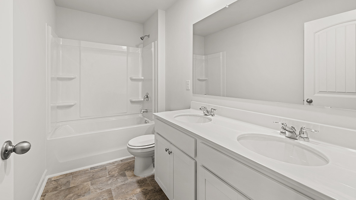 Interior bathroom with double sink and full-sized shower
