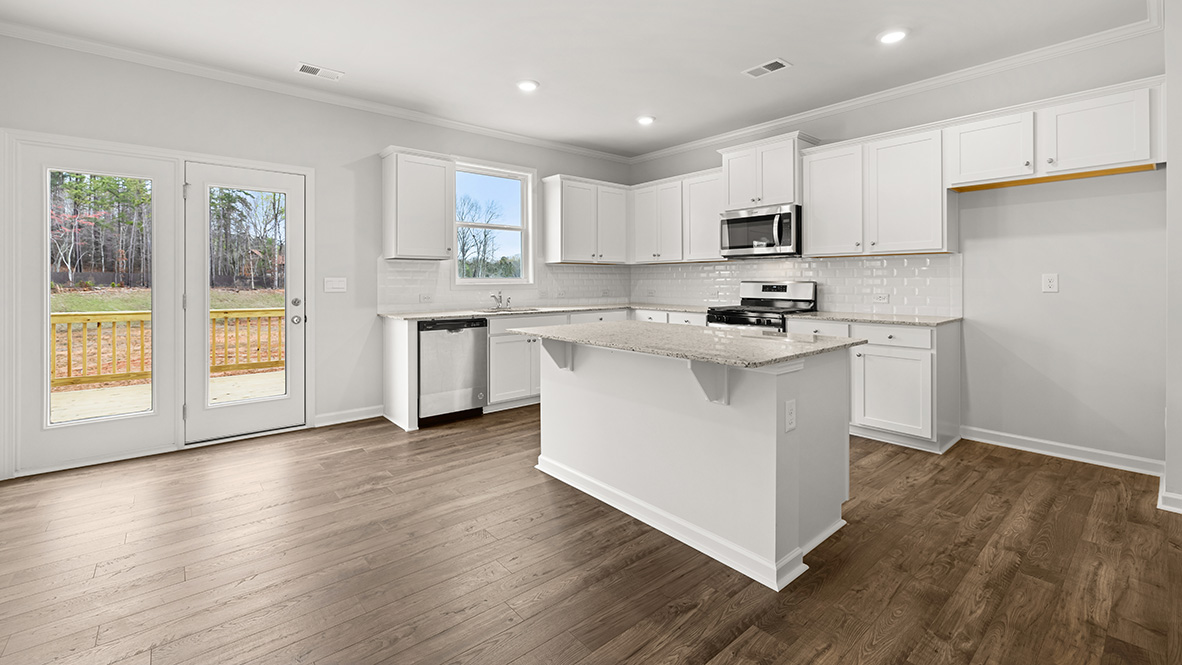 Interior kitchen with center island and white cabinets