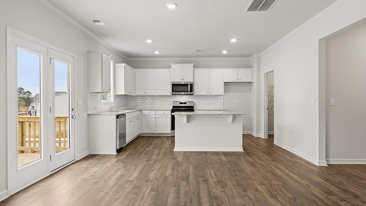 Interior kitchen with center island and white cabinets