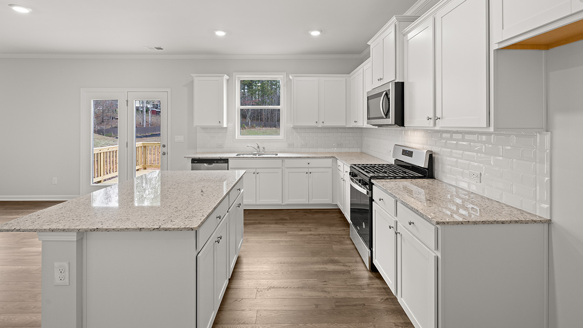 Interior kitchen with center island and white cabinets