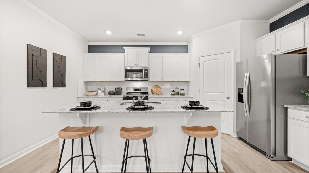 Interior kitchen with center island and white cabinets