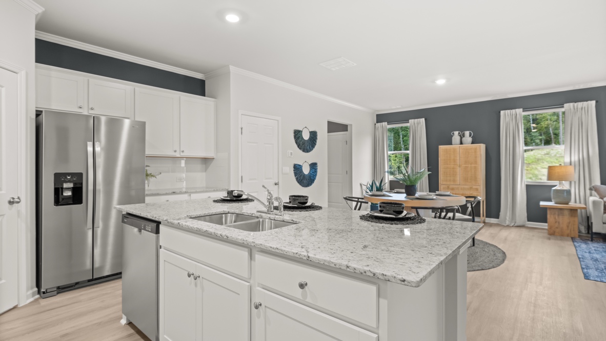 Interior kitchen with center island and white cabinets