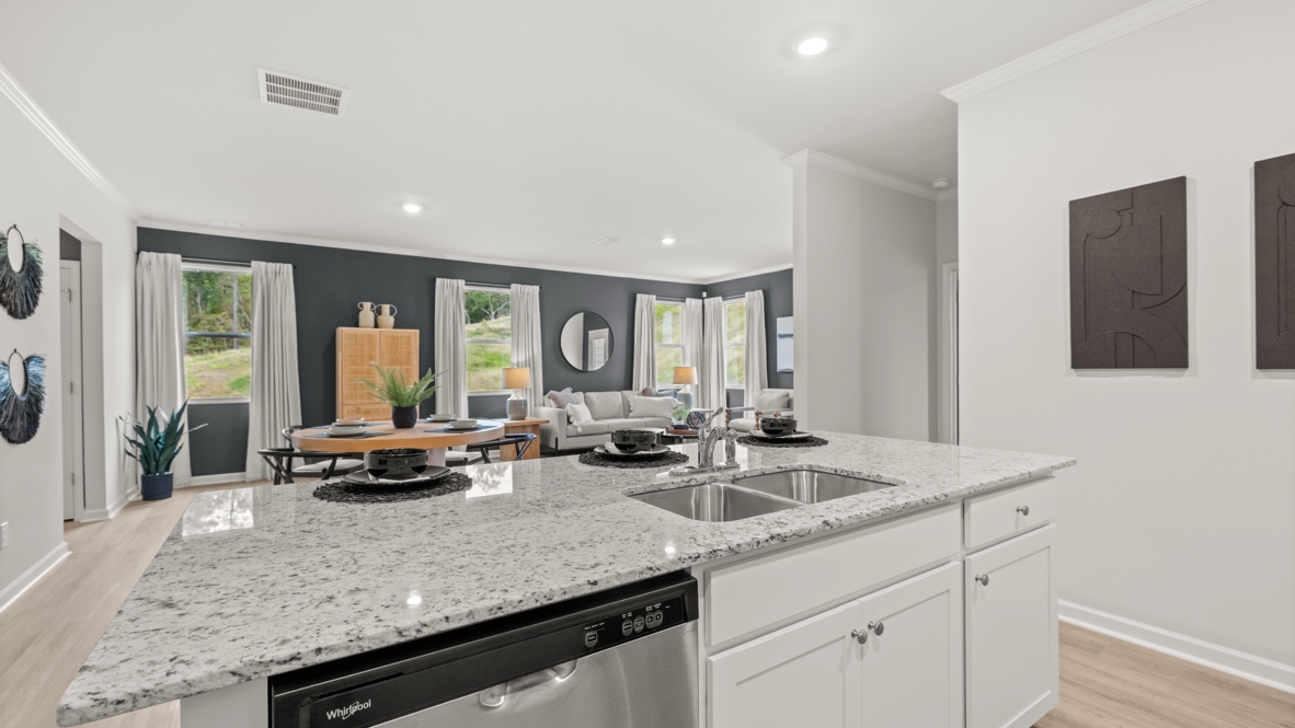 Interior kitchen with center island and white cabinets