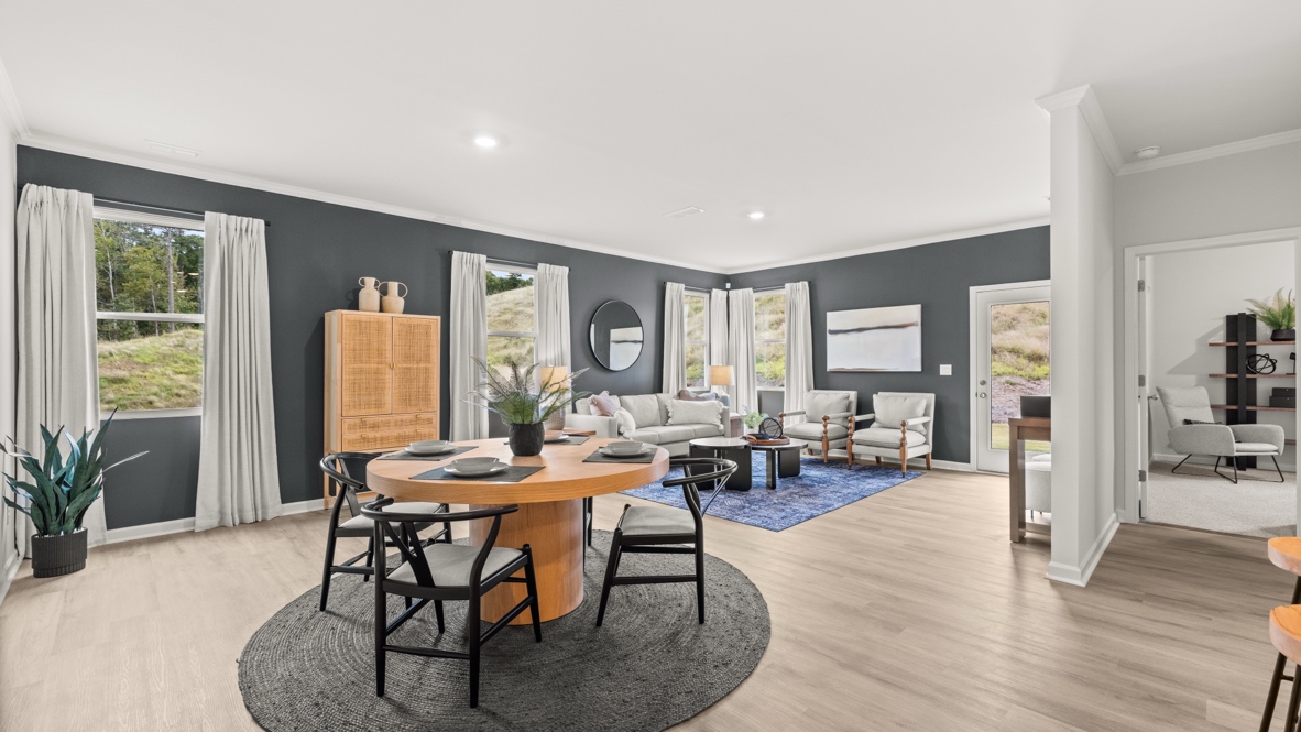 Interior dining area open to living area with large windows