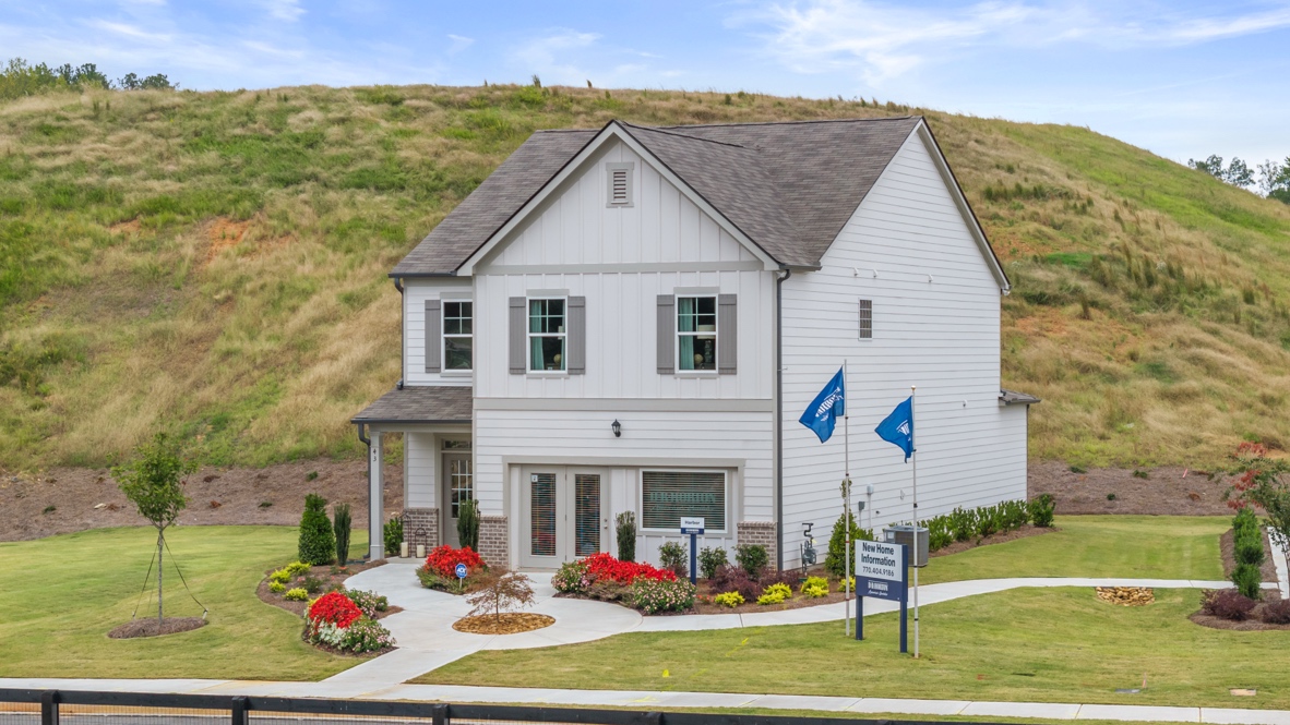Exterior two-story home with cladding and stone detailing