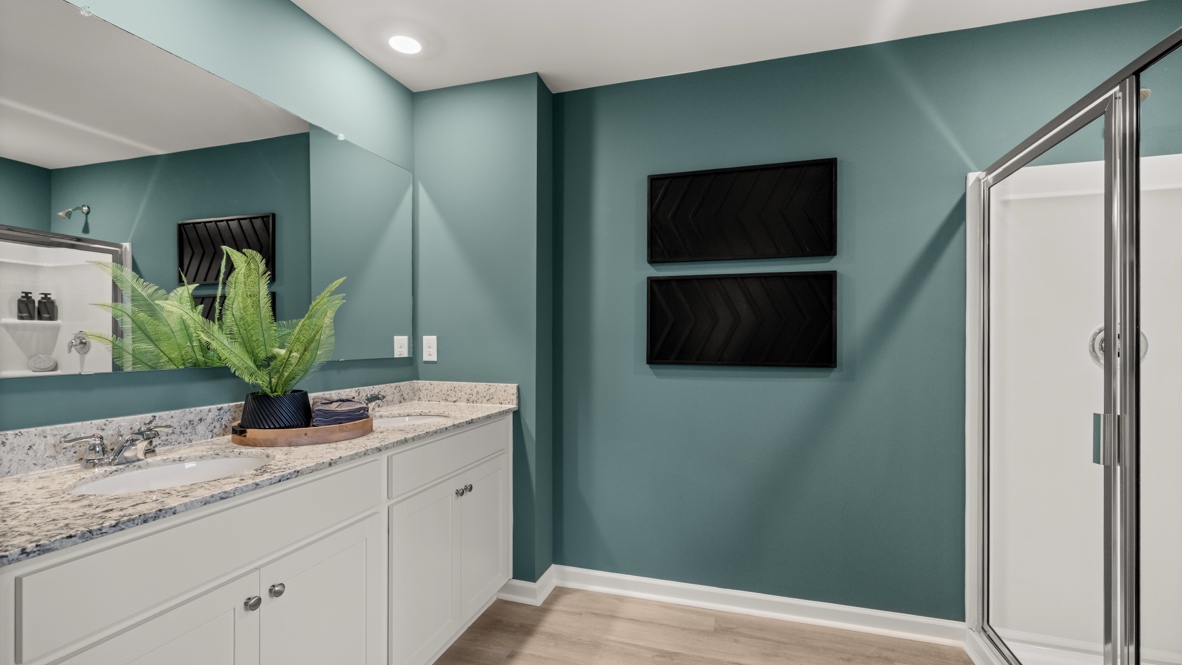 Interior primary bathroom with double sink and shower