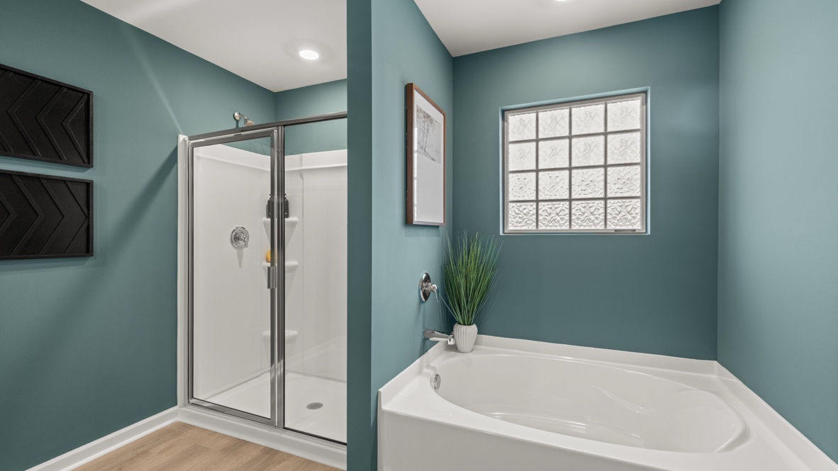 Interior primary bathroom with shower and bath tub