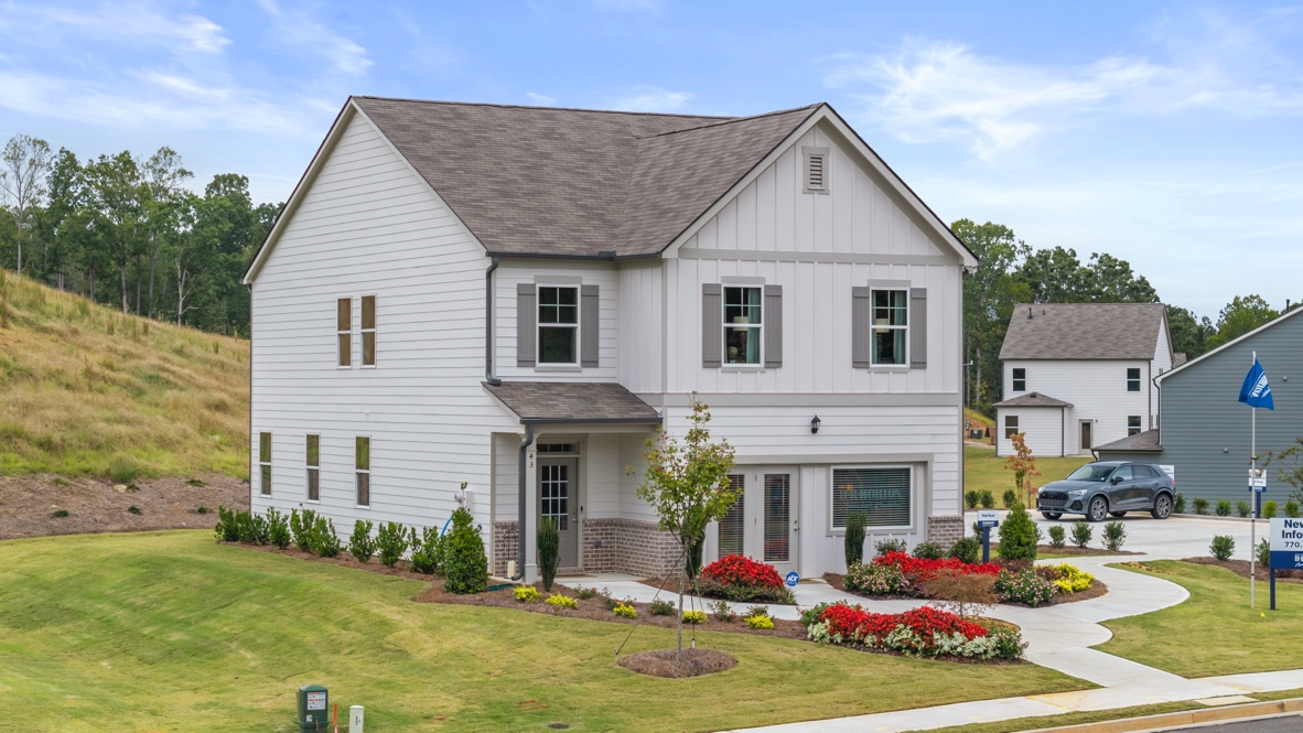 Exterior two-story home with cladding and stone detailing