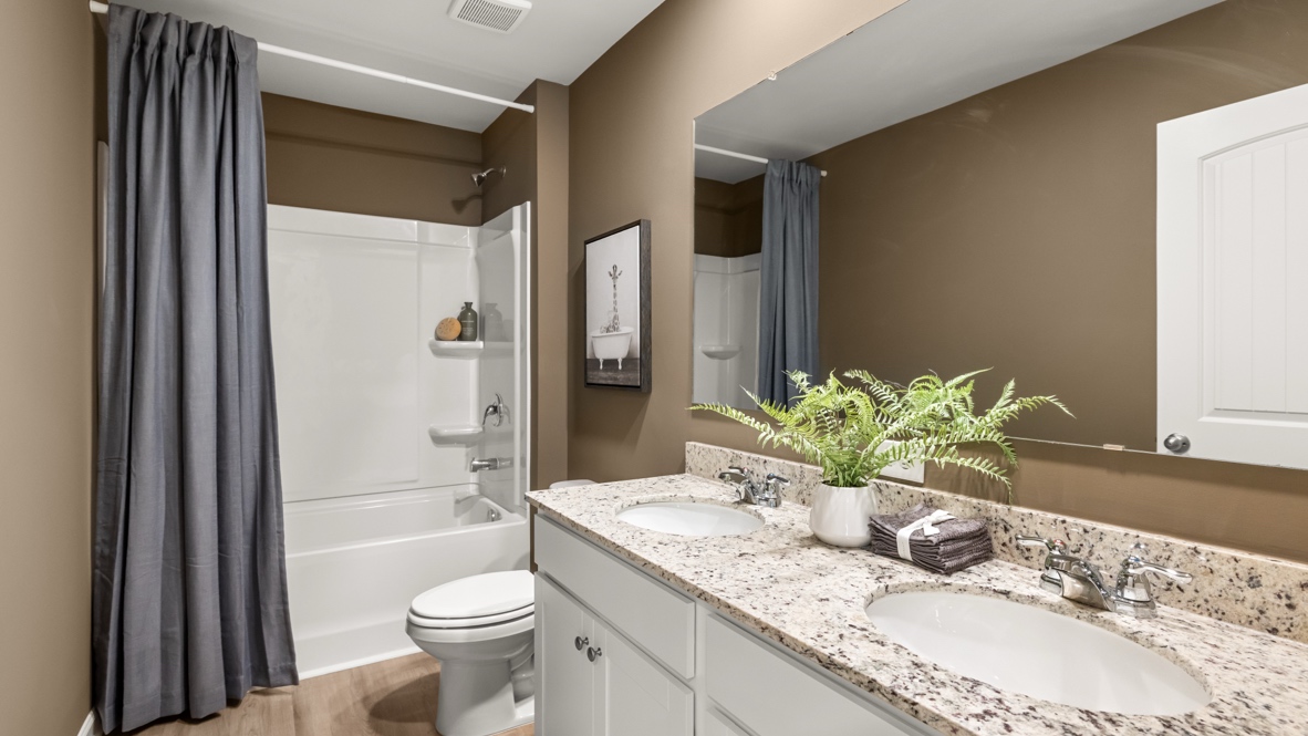 Interior bathroom with double sink and full-sized shower