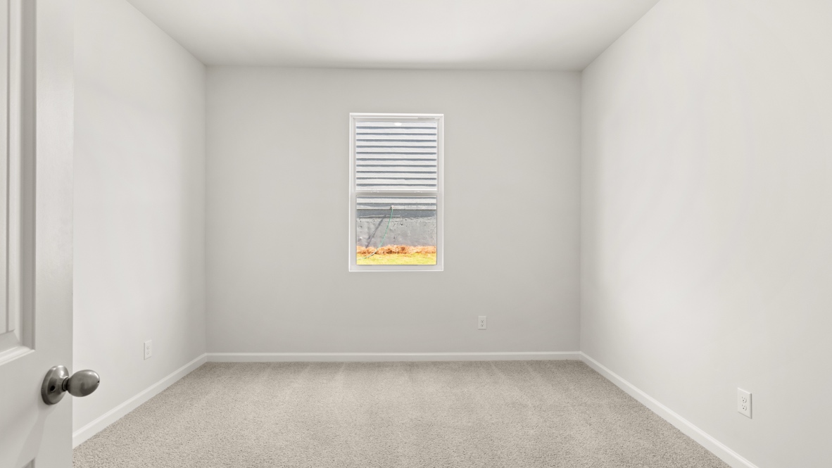 Bedroom with carpet flooring, multiple doors, and open view to hallway