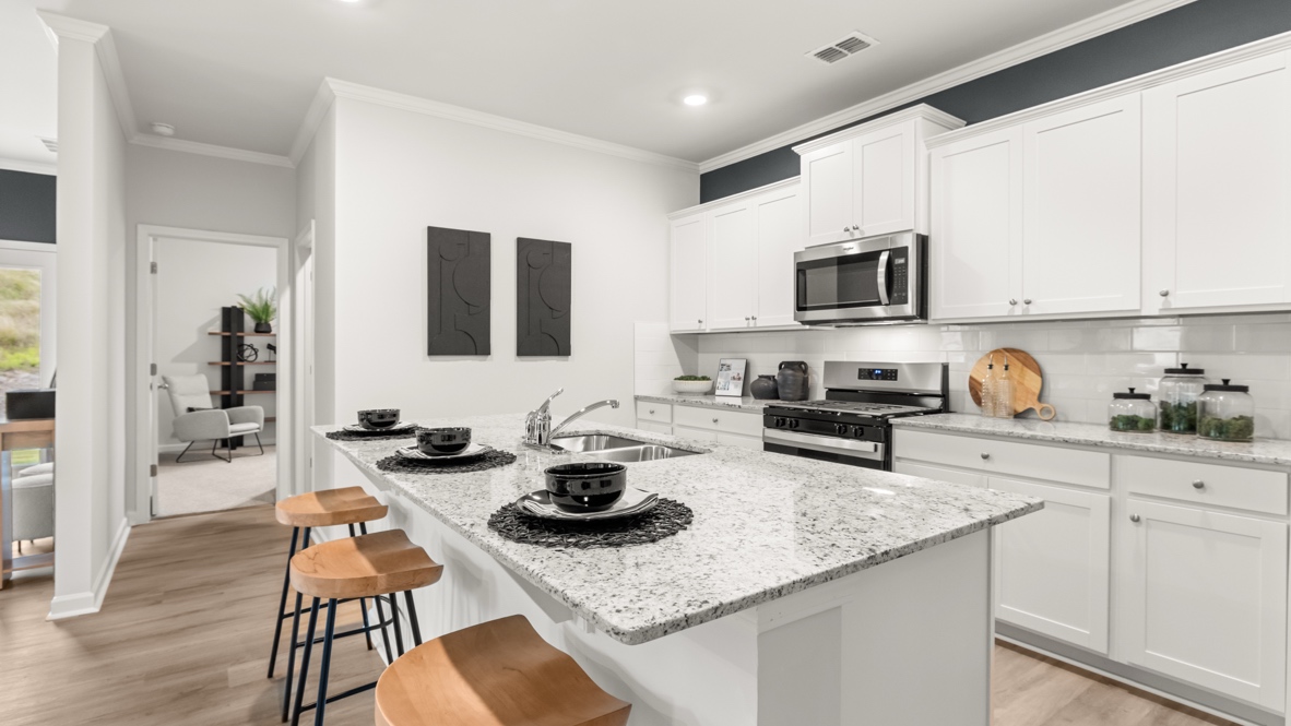 Interior kitchen with center island and white cabinets Sheffield Highlands By D.R. Horton, Dallas, GA