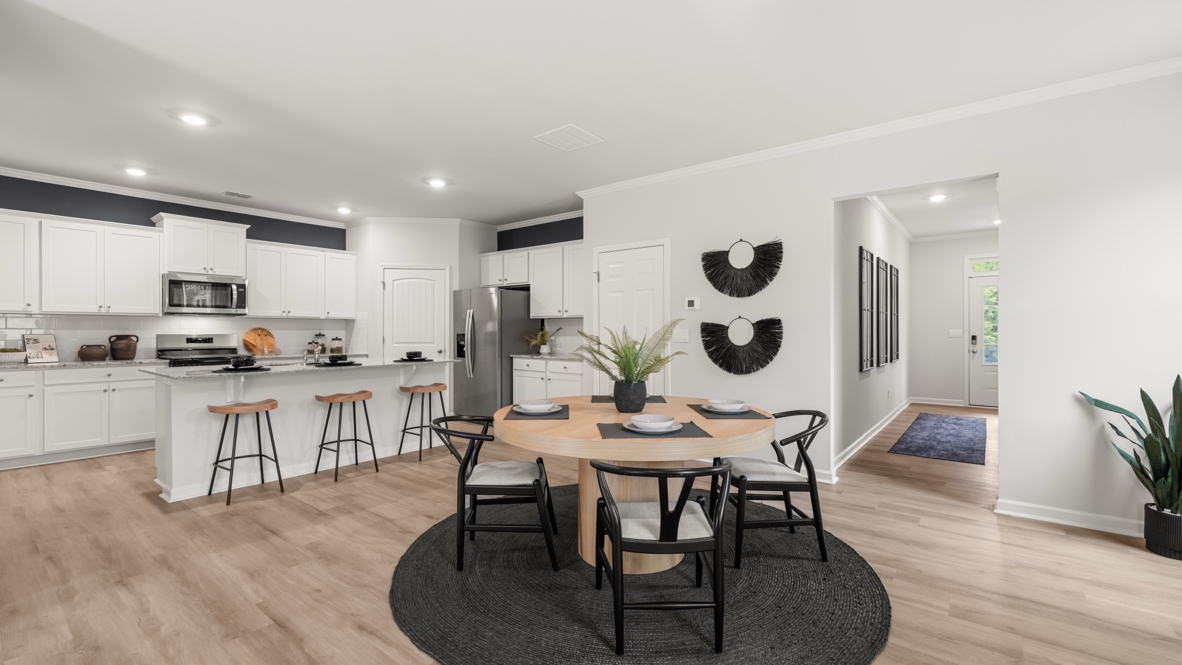 Interior dining area open to living area with large windowsSheffield Highlands By D.R. Horton, Dallas, GA