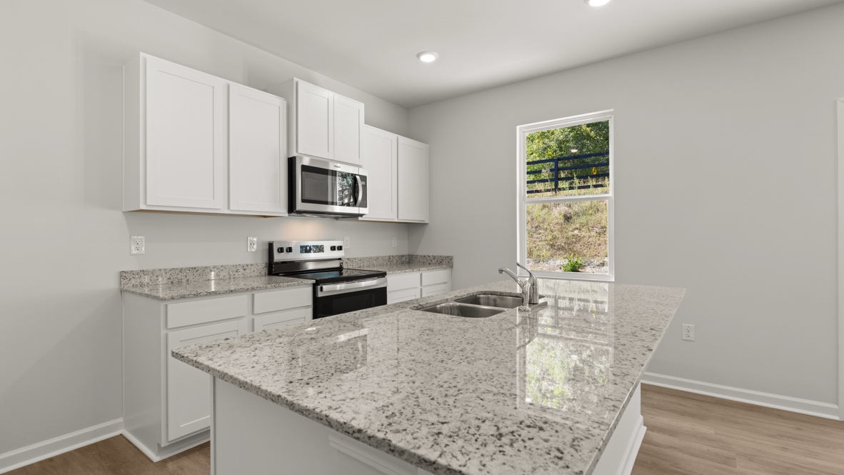 Interior kitchen with center island and white cabinets