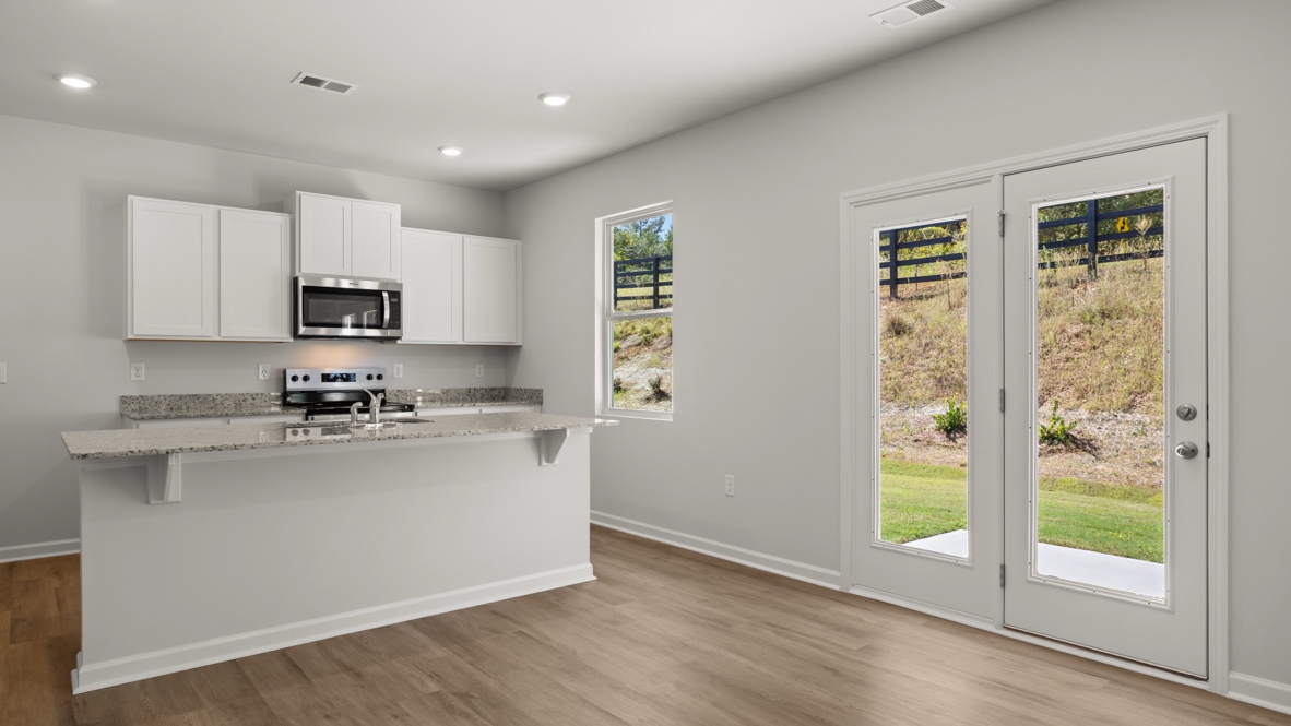 Interior kitchen with center island and white cabinets