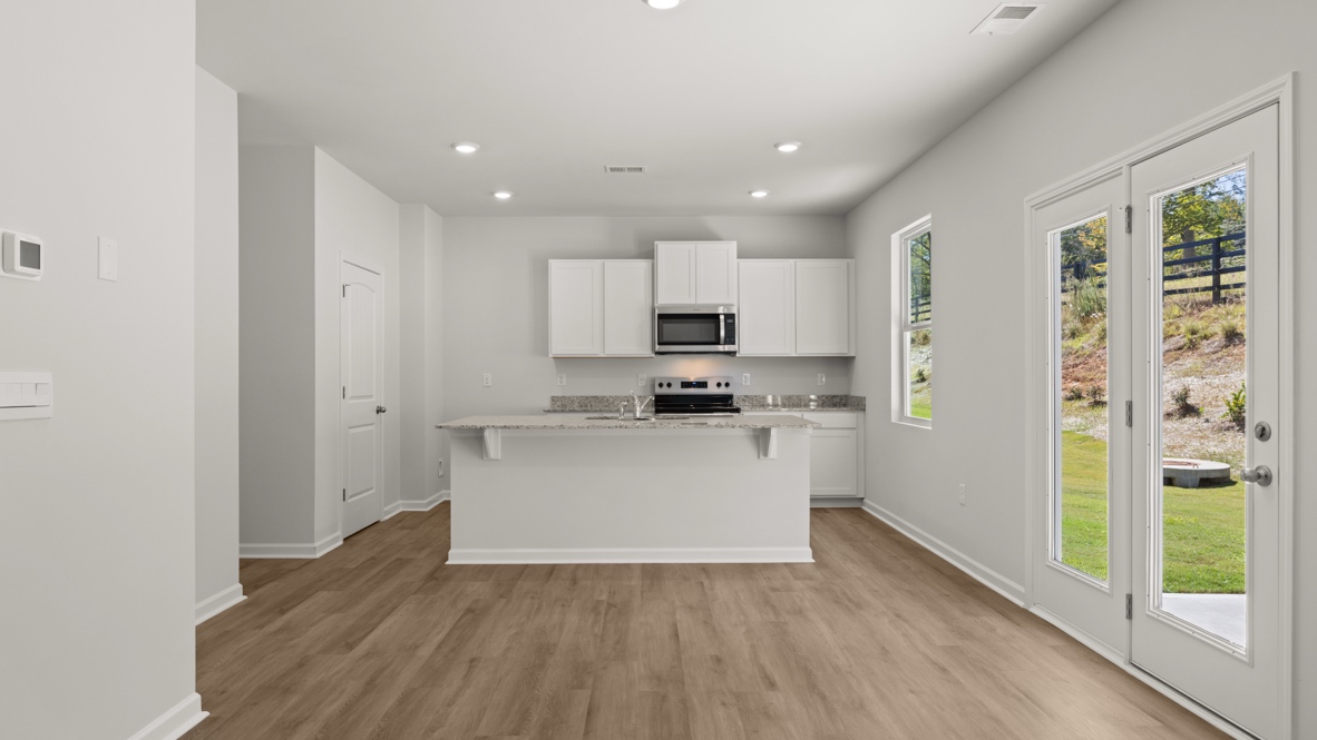 Interior kitchen with center island and white cabinets