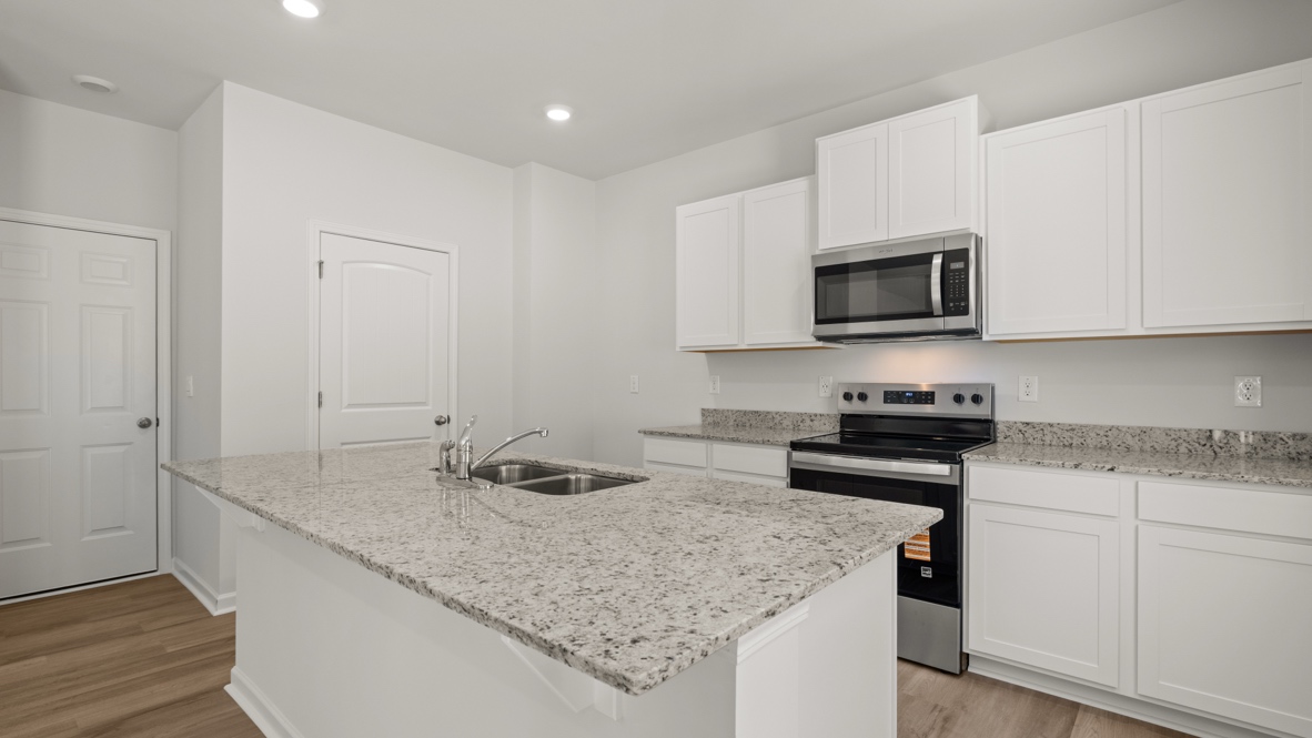 Interior kitchen with center island and white cabinets