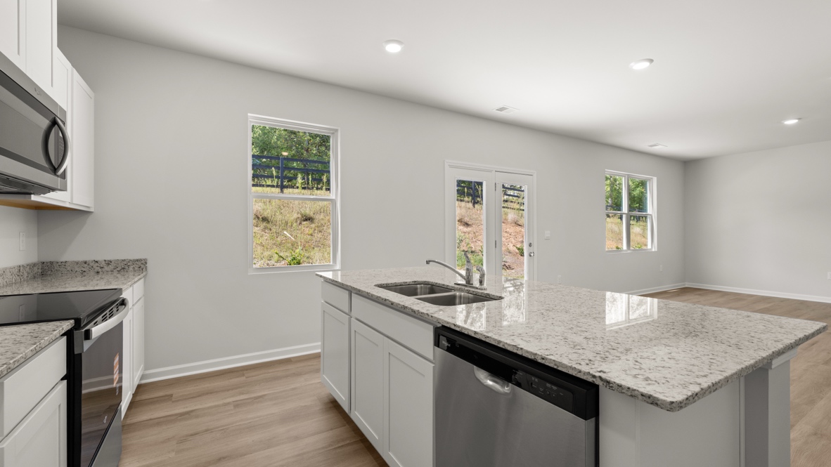 Interior kitchen with center island and white cabinets