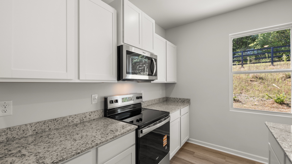 Interior kitchen with center island and white cabinets