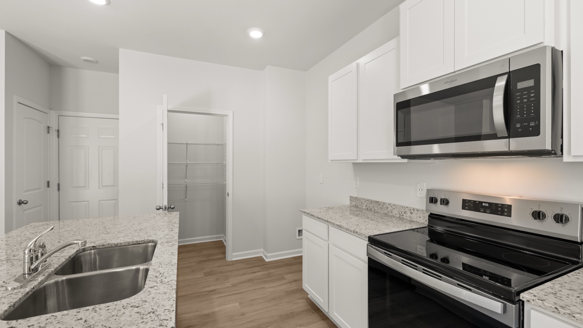 Interior kitchen with center island and white cabinets