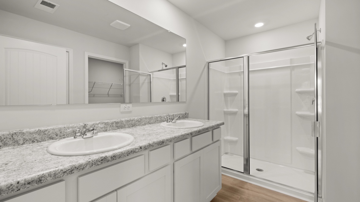 Interior primary bathroom with double sink and shower