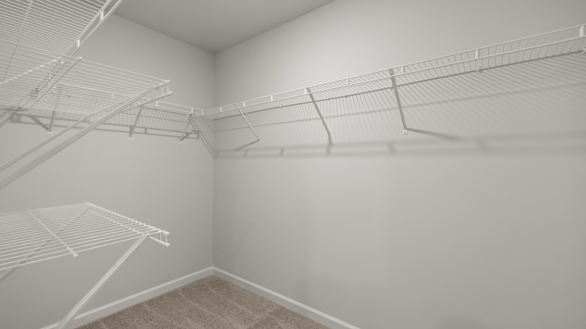 Interior primary bathroom with walk-in closet