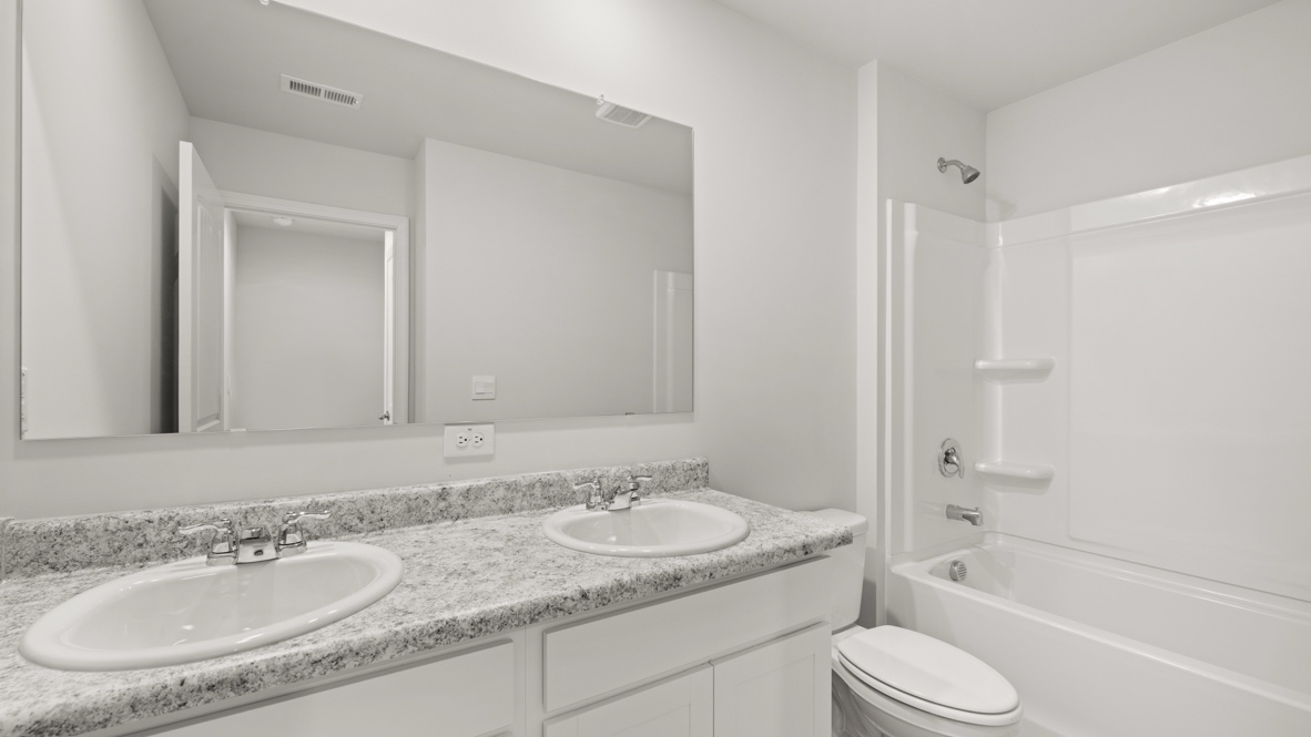 Interior bathroom with double sink and full-sized shower