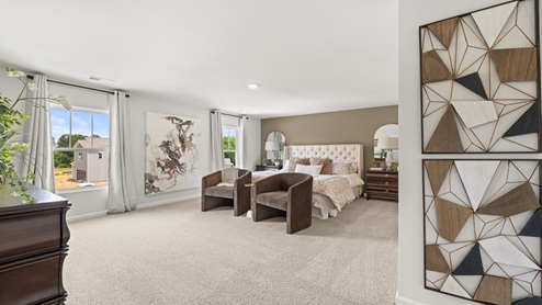 two story model home primary bedroom