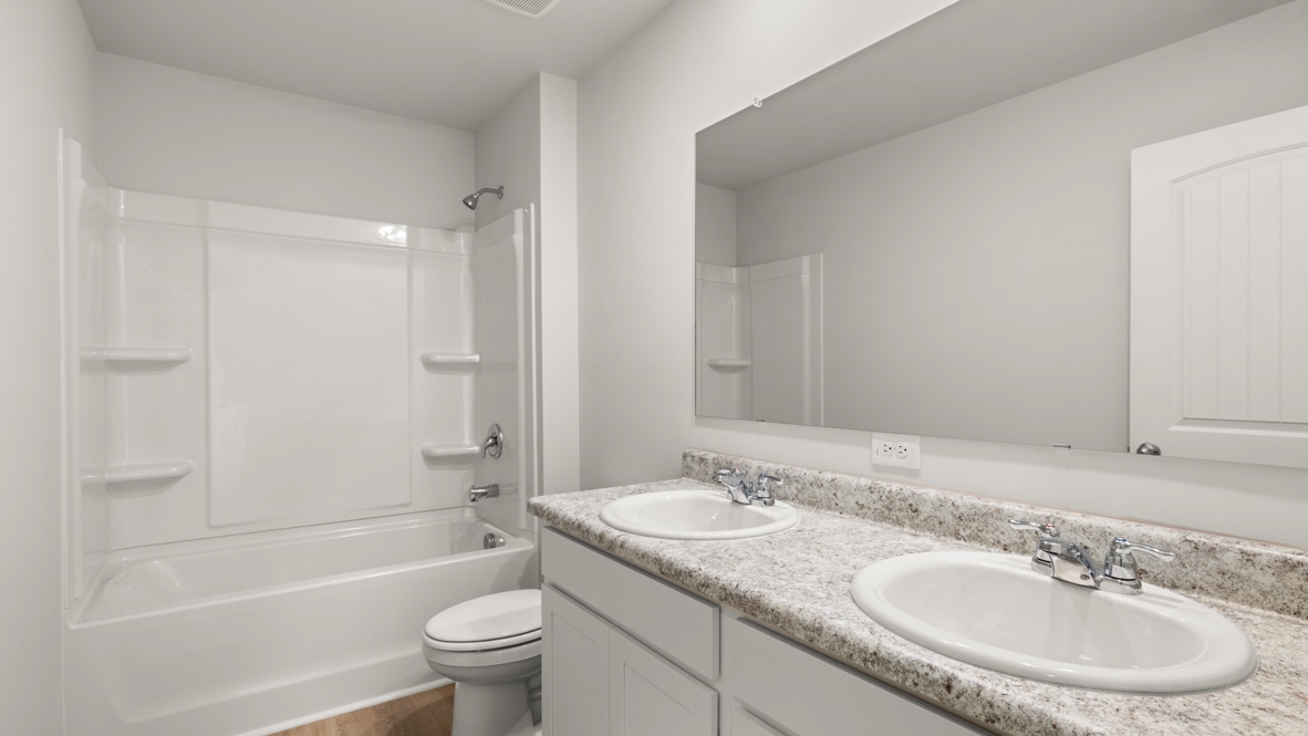 Interior bathroom with double sink and full-sized shower