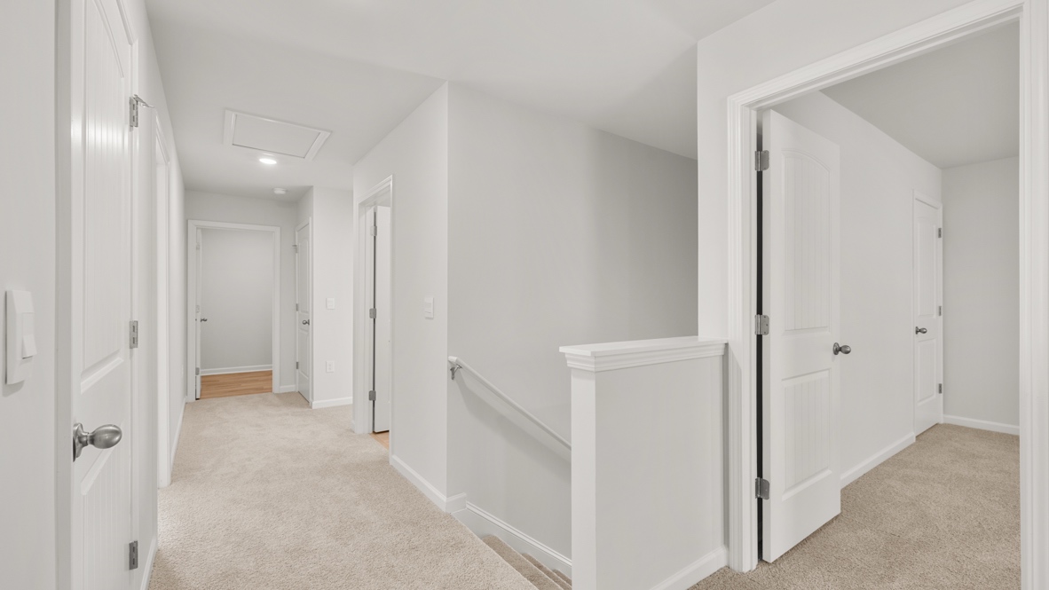 Interior upstairs hallway open to staircase